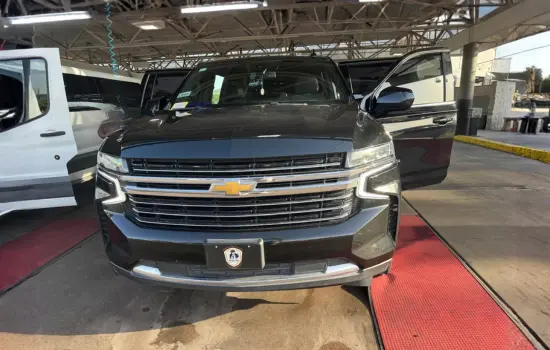 A luxury black SUV being cleaned for airport car service